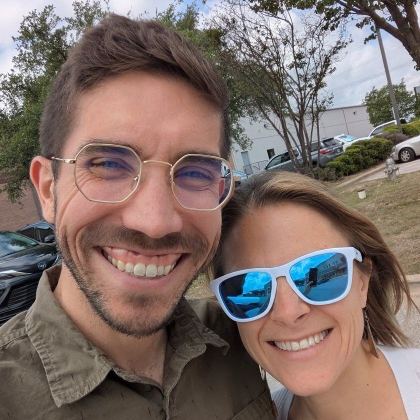 TC Schilling outdoors with his wife, both smiling at the camera.